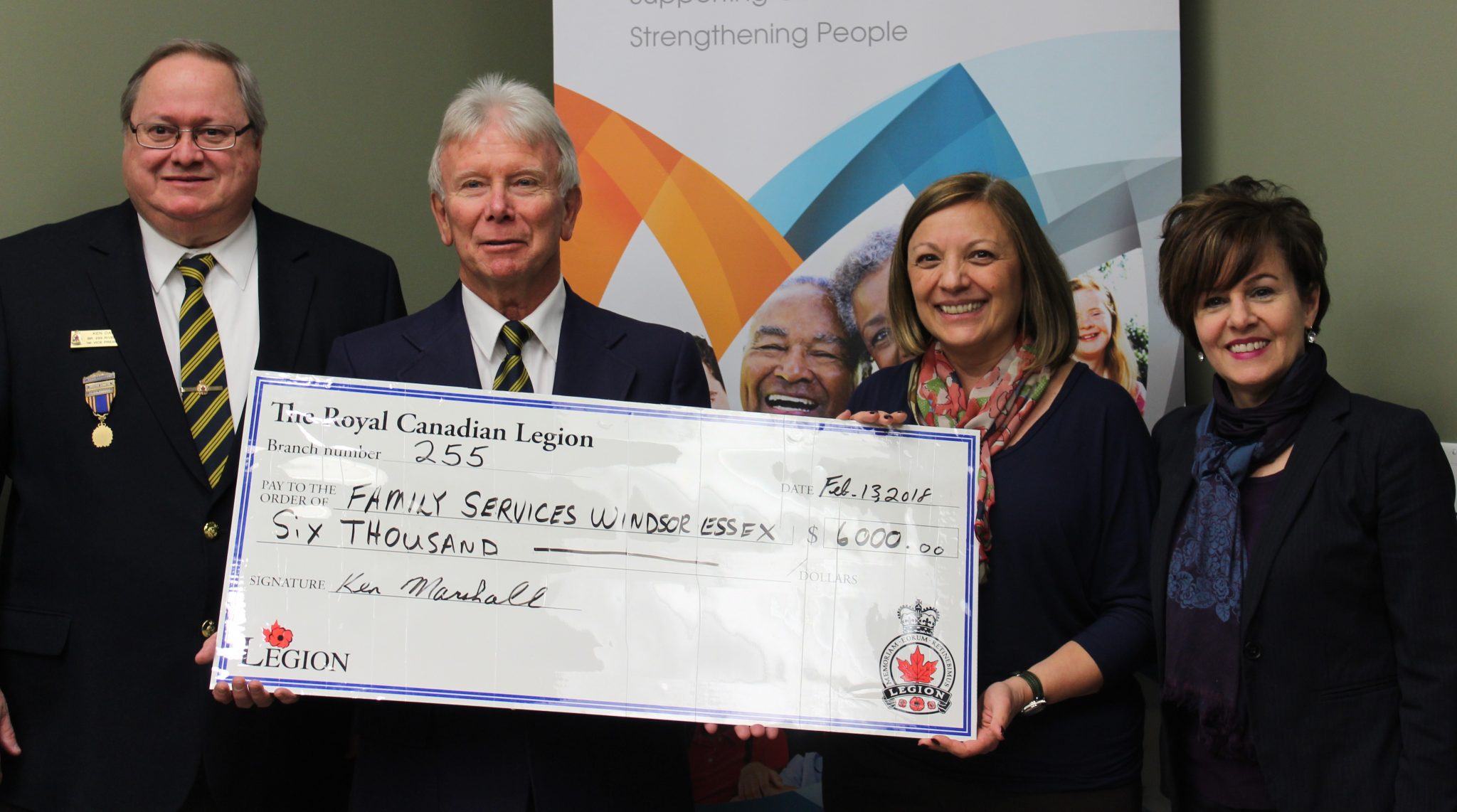 Royal Canadian Legion Members Ken Dault and Ken Marshall holding large $6,000 cheque with Joyce Zuk and Beth Anne Ternovan from Family Services Windsor Essex